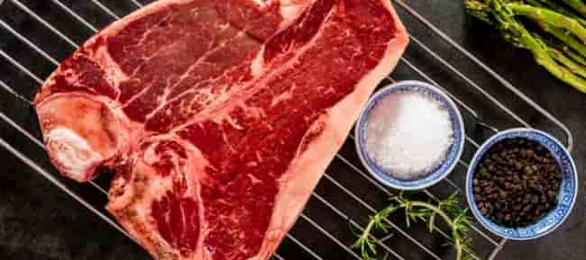 Season steak with salt